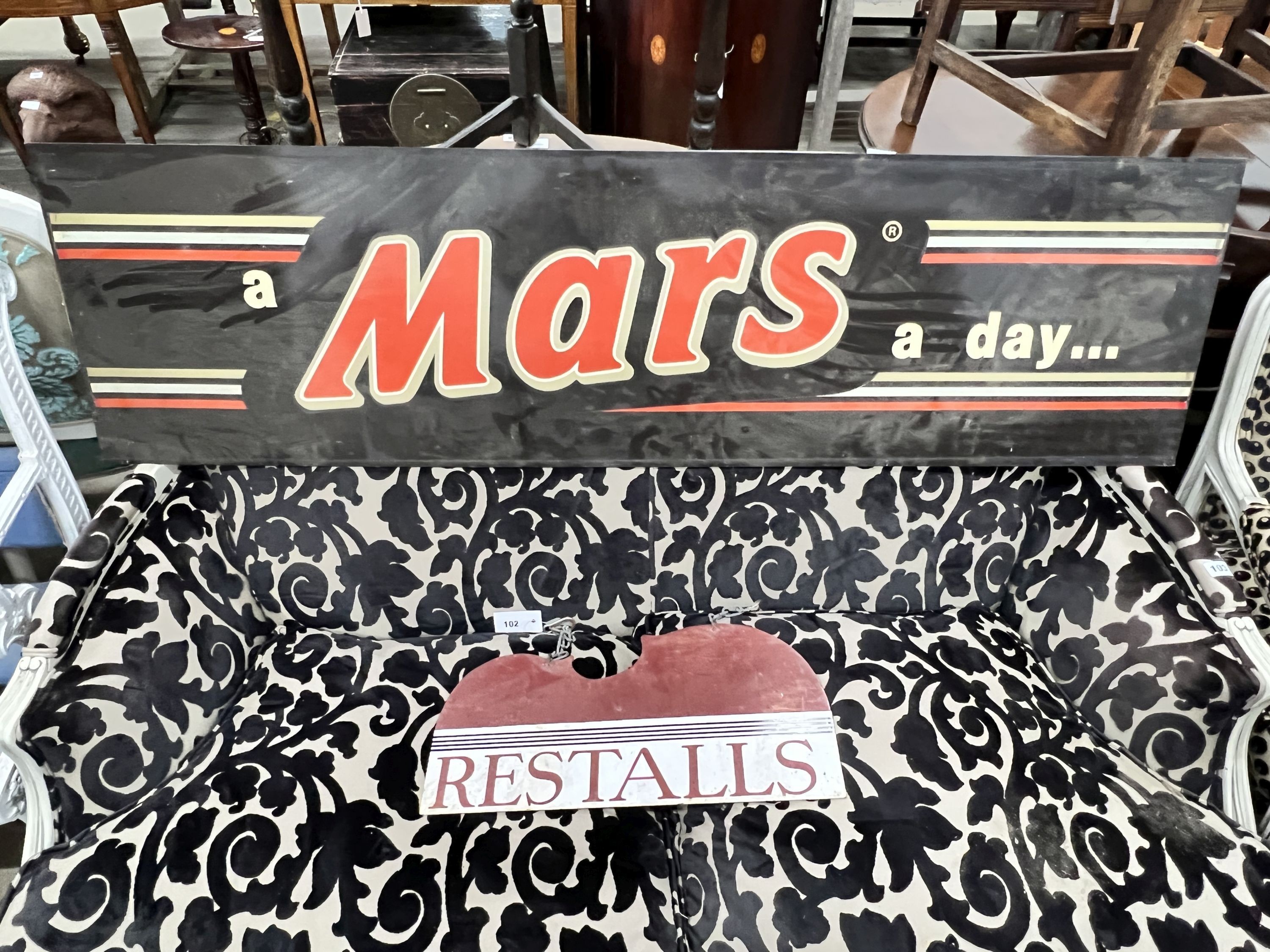 A 'Mars' chocolate advertising sign, length 153cm, height 42cm, and a 'Restalls' enamelled hanging sign